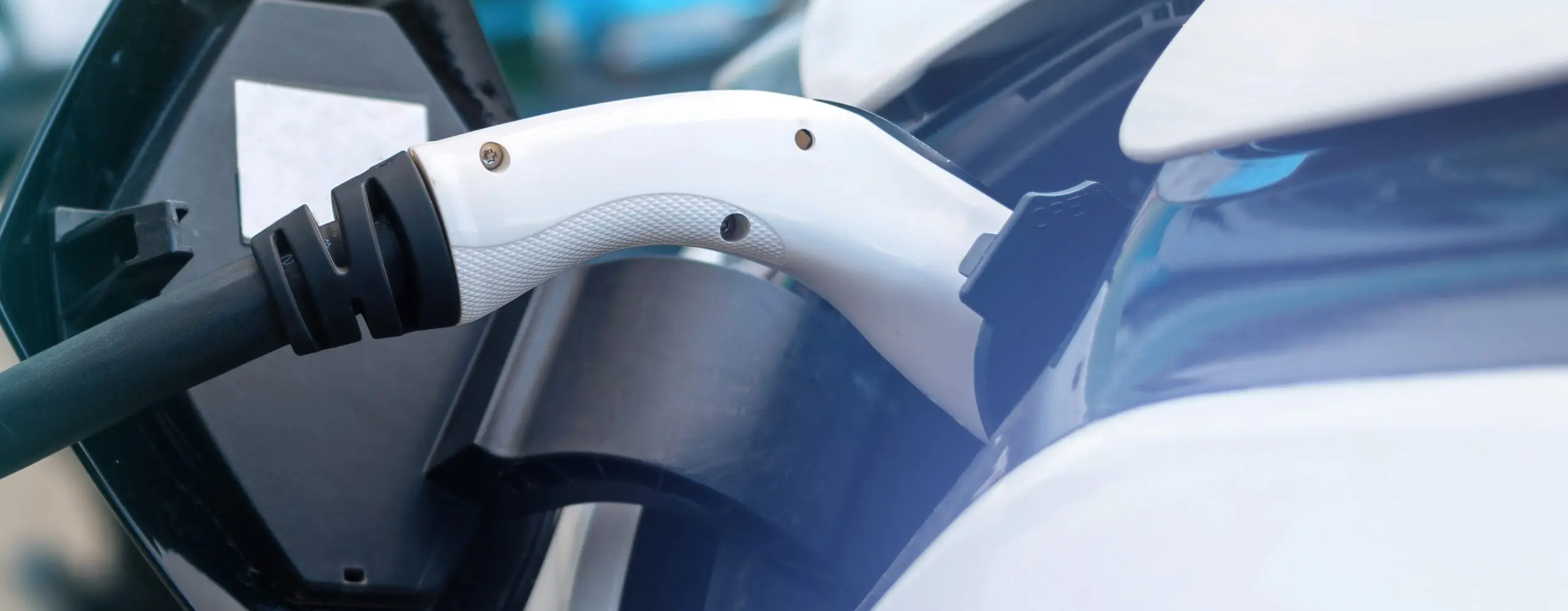 Plugged in chargers into two electric cars at charge station